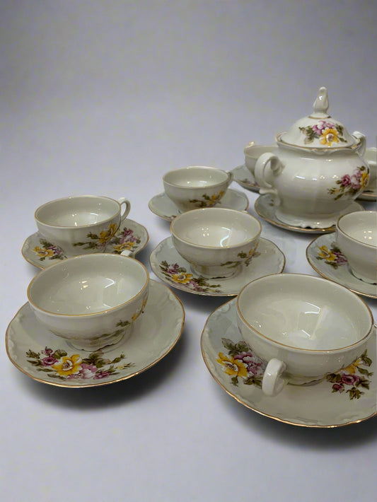 Vintage 1970s Italian porcelain tea set by Tognana with hand-painted floral pattern, 11 cups, 12 saucers, and a sugar bowl with gold trim.