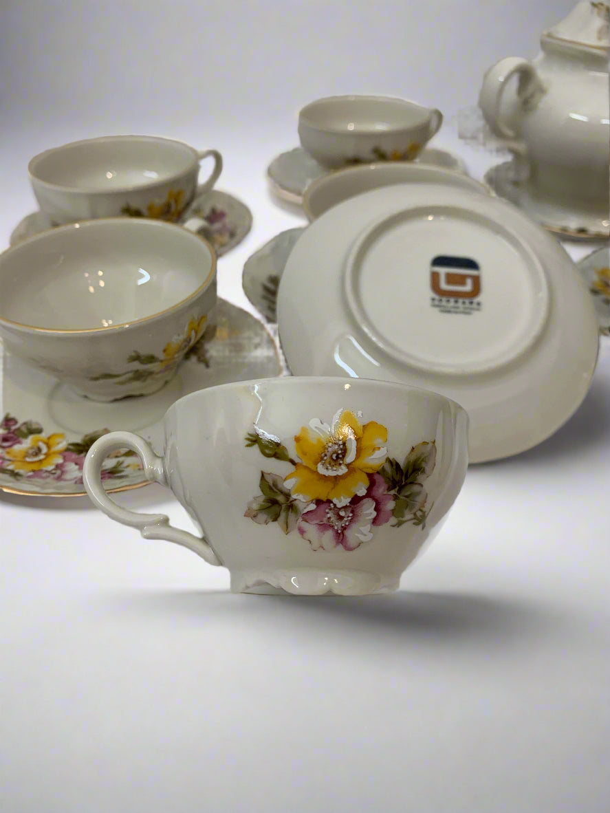 Vintage 1970s Italian porcelain tea set by Tognana with hand-painted floral pattern, 11 cups, 12 saucers, and a sugar bowl with gold trim.