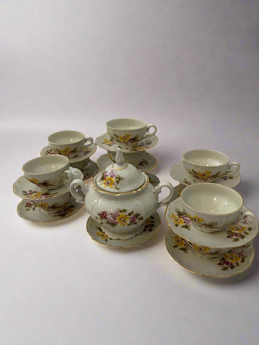 Vintage 1970s Italian porcelain tea set by Tognana with hand-painted floral pattern, 11 cups, 12 saucers, and a sugar bowl with gold trim.