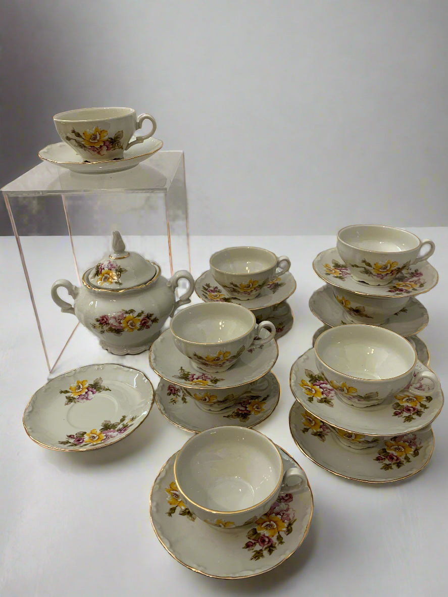 Vintage 1970s Italian porcelain tea set by Tognana with hand-painted floral pattern, 11 cups, 12 saucers, and a sugar bowl with gold trim.