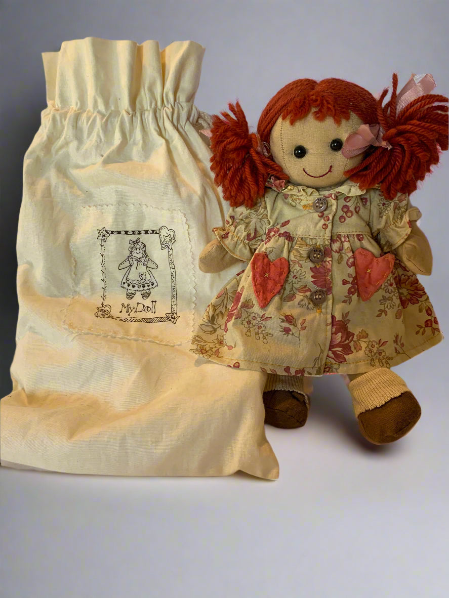 Vintage 1990s My Doll cloth doll with red yarn hair, original dress, cotton storage bag, and complete handmade clothing wardrobe – made in Italy.
