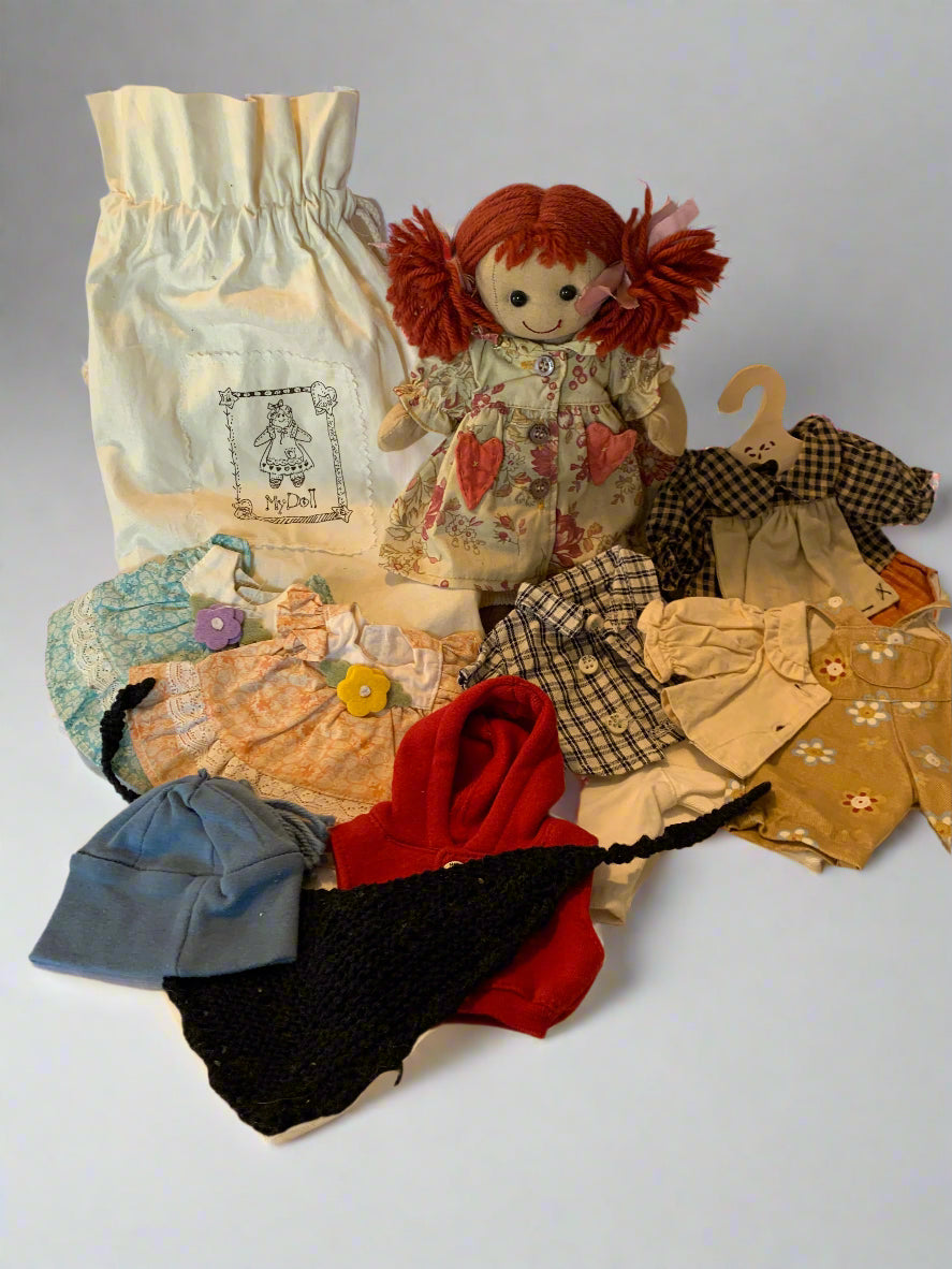 Vintage 1990s My Doll cloth doll with red yarn hair, original dress, cotton storage bag, and complete handmade clothing wardrobe – made in Italy.
